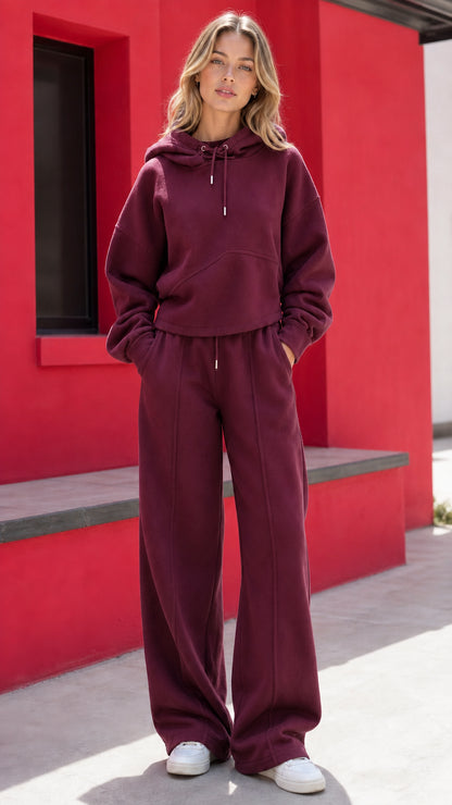 Woman wearing burgundy wine two-piece fleece hoodie and wide-leg pants set