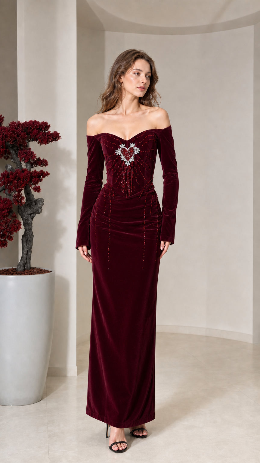 Front view of model wearing burgundy velvet off-the-shoulder maxi dress