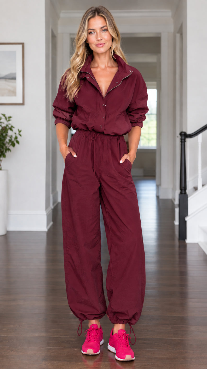 Model wearing burgundy red casual long sleeve utility parachute jumpsuit