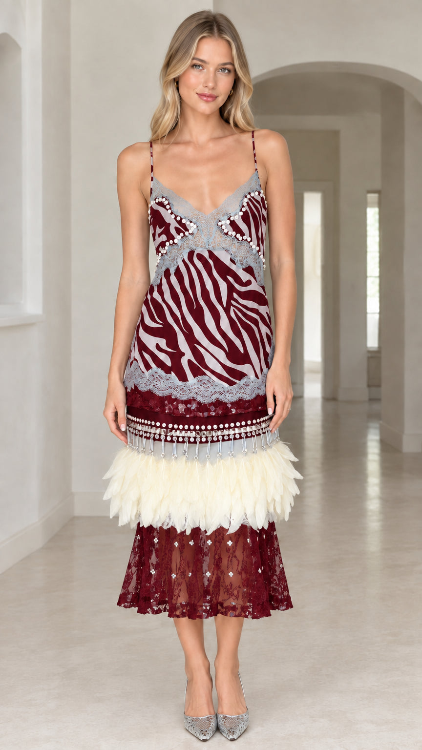 Model wearing Burgundy zebra print feather trimmed slip midi dress