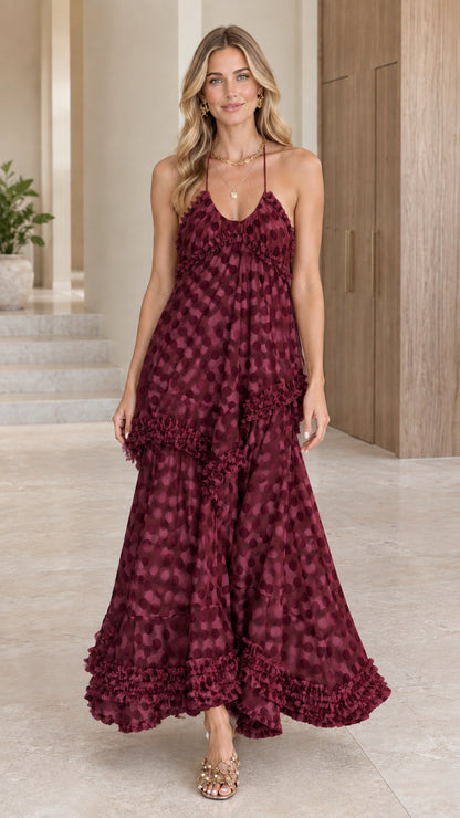 Model wearing a rich burgundy wine polka dot halter tiered maxi dress