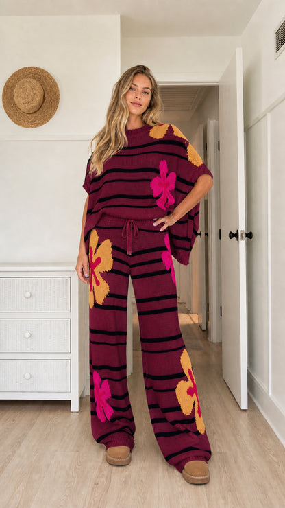 Model wearing burgundy floral striped knit relaxed sweater and pant set