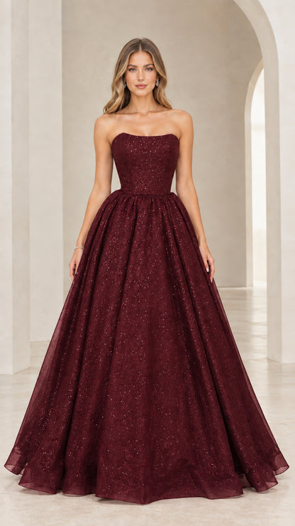 Front view of model in burgundy wine red strapless glitter ball gown