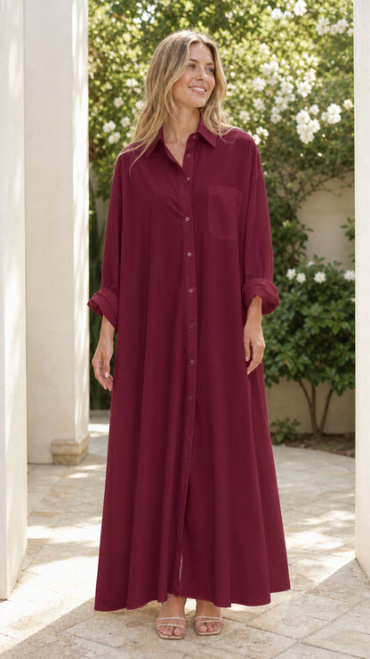 Woman wearing rich burgundy button-down floor-length shirt dress