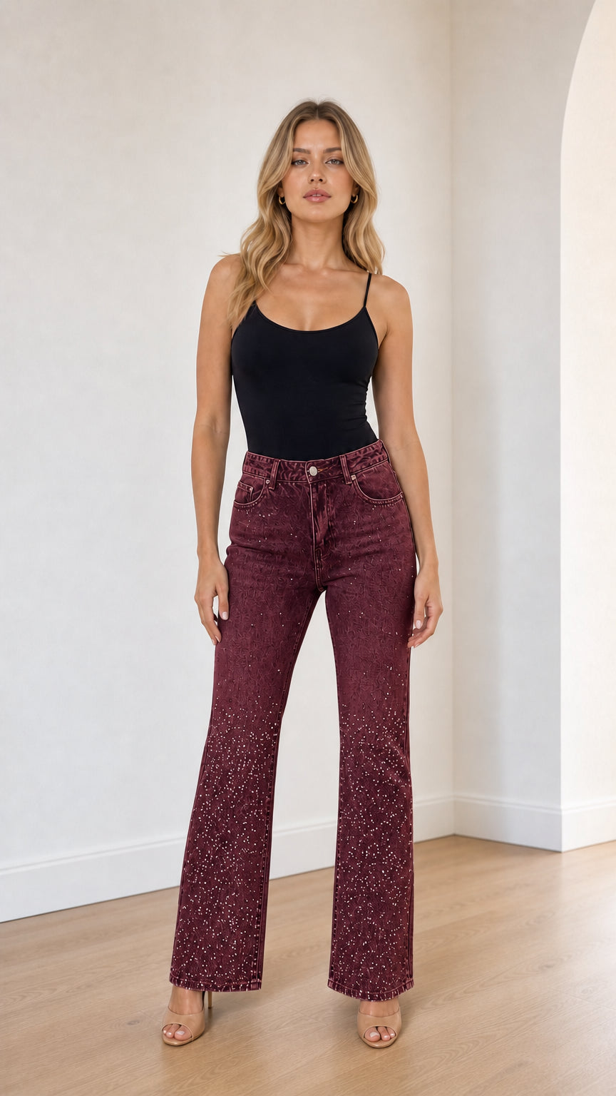 Full front view of model wearing burgundy wine rhinestone studded flare jeans