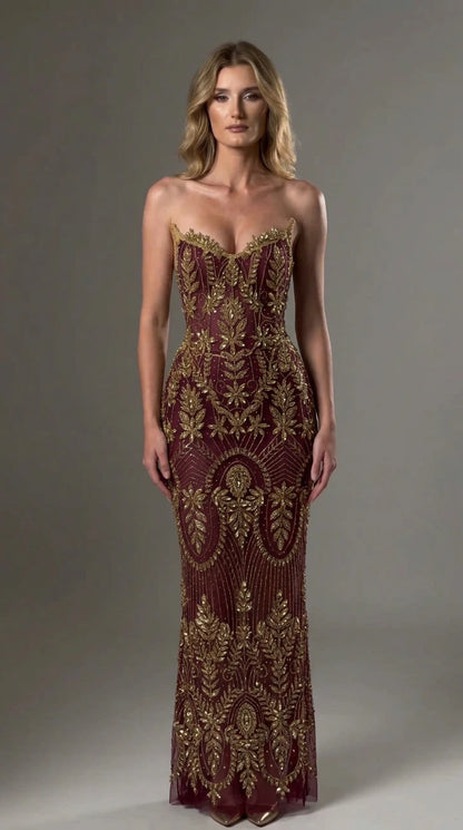 Front view of model wearing burgundy and gold strapless beaded formal evening gown