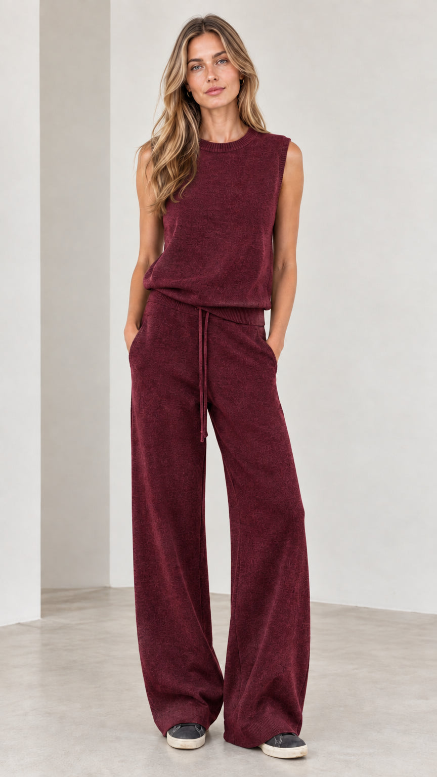 Full-body view of woman wearing Burgundy sleeveless top and wide-leg knit pants set