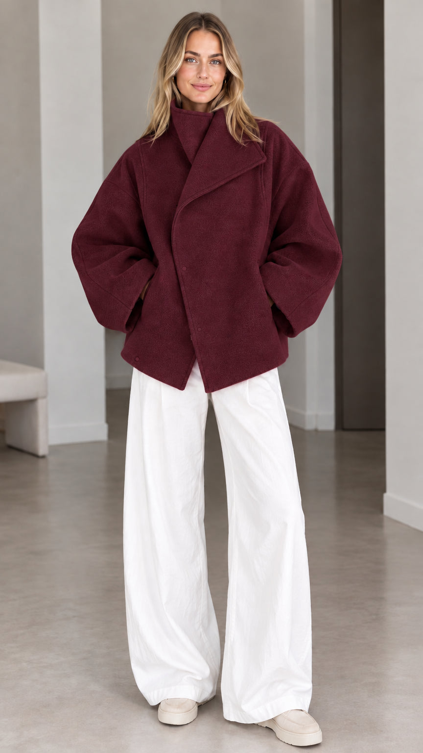 Model wearing deep burgundy wine asymmetrical snap-front short coat