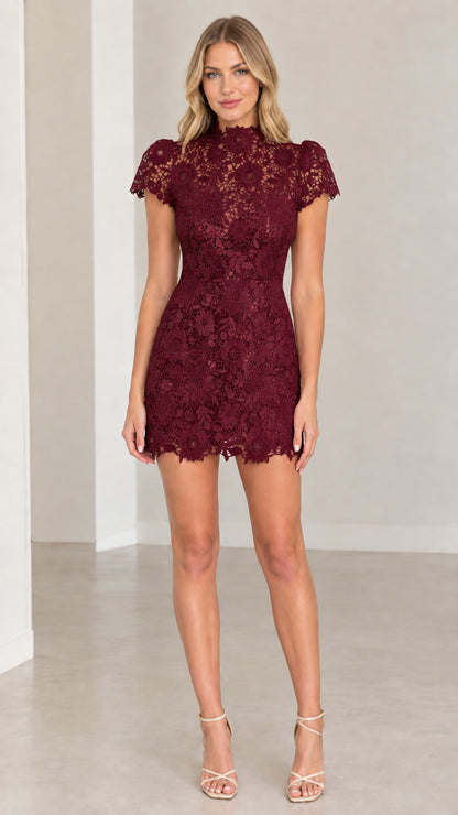 Front view of model wearing burgundy floral lace mock neck mini dress