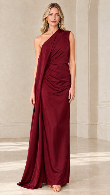 Front view of woman wearing Burgundy one-shoulder draped maxi evening gown