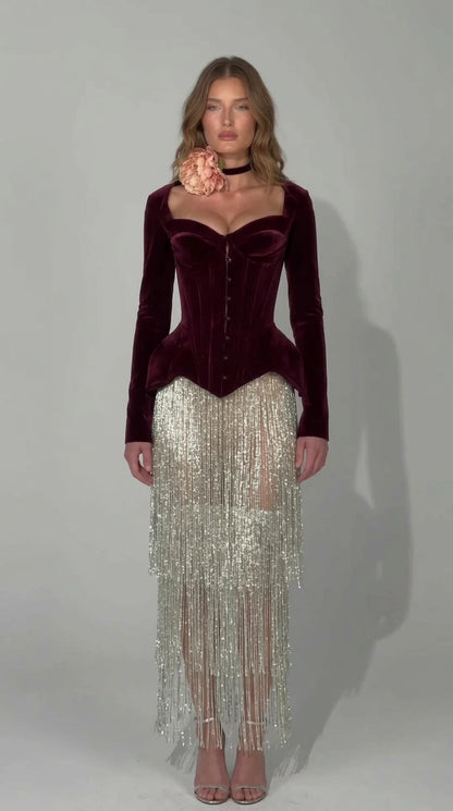 Front view of rich burgundy wine velvet corset dress with silver fringe skirt