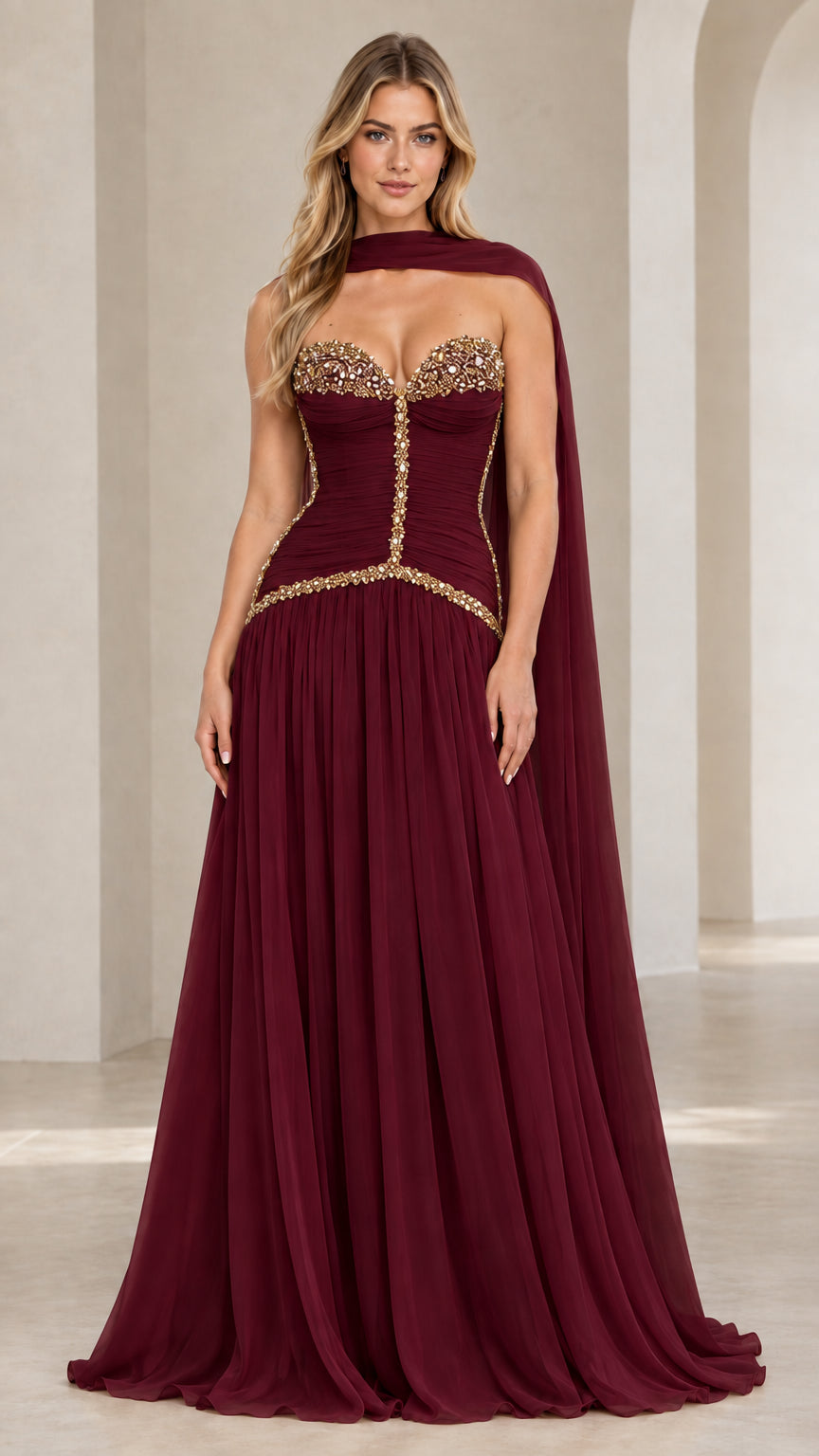 Model wearing burgundy red strapless embellished corset chiffon evening gown with matching neck scarf