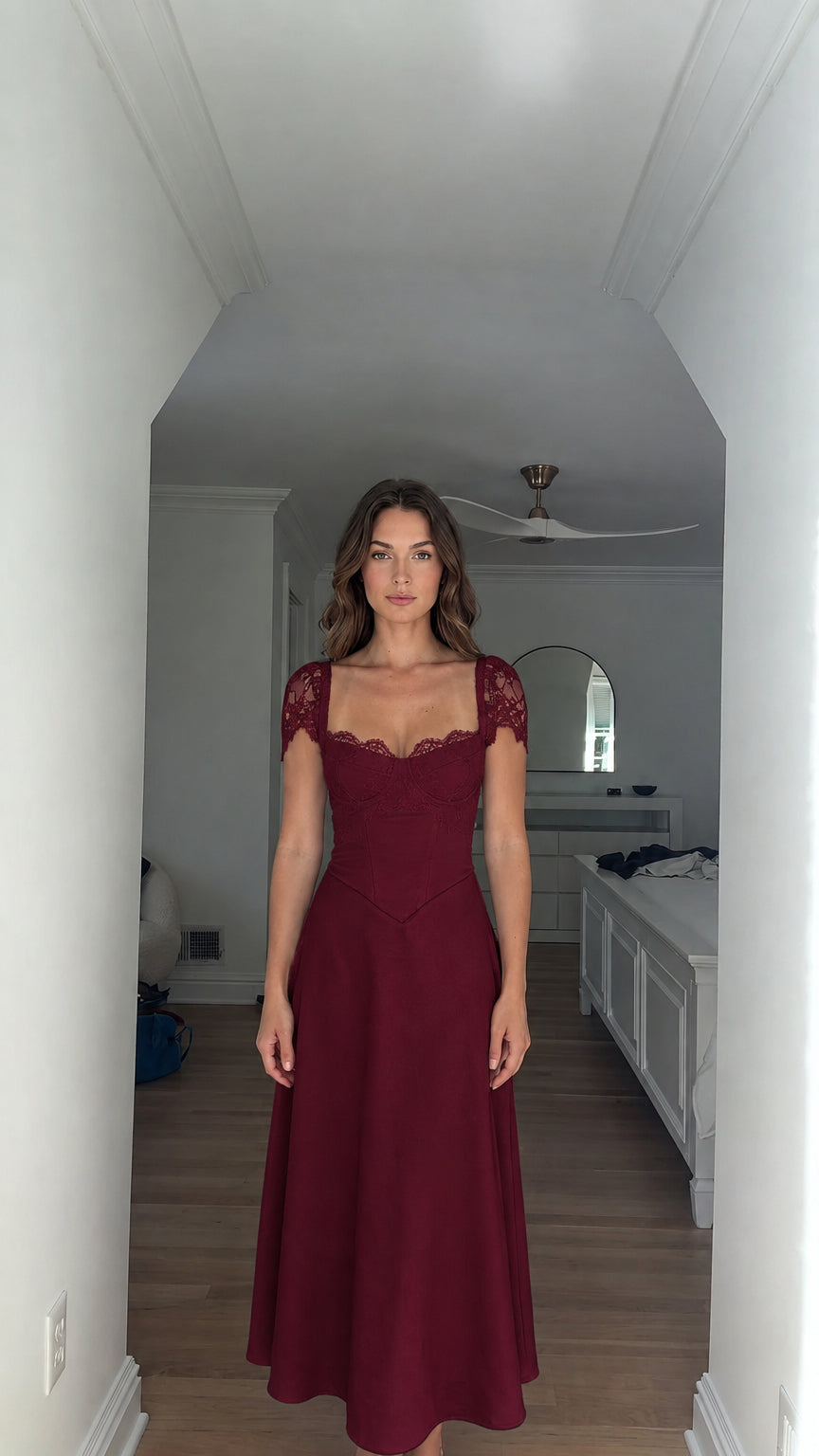 Model wearing burgundy red lace cap-sleeve corset maxi dress