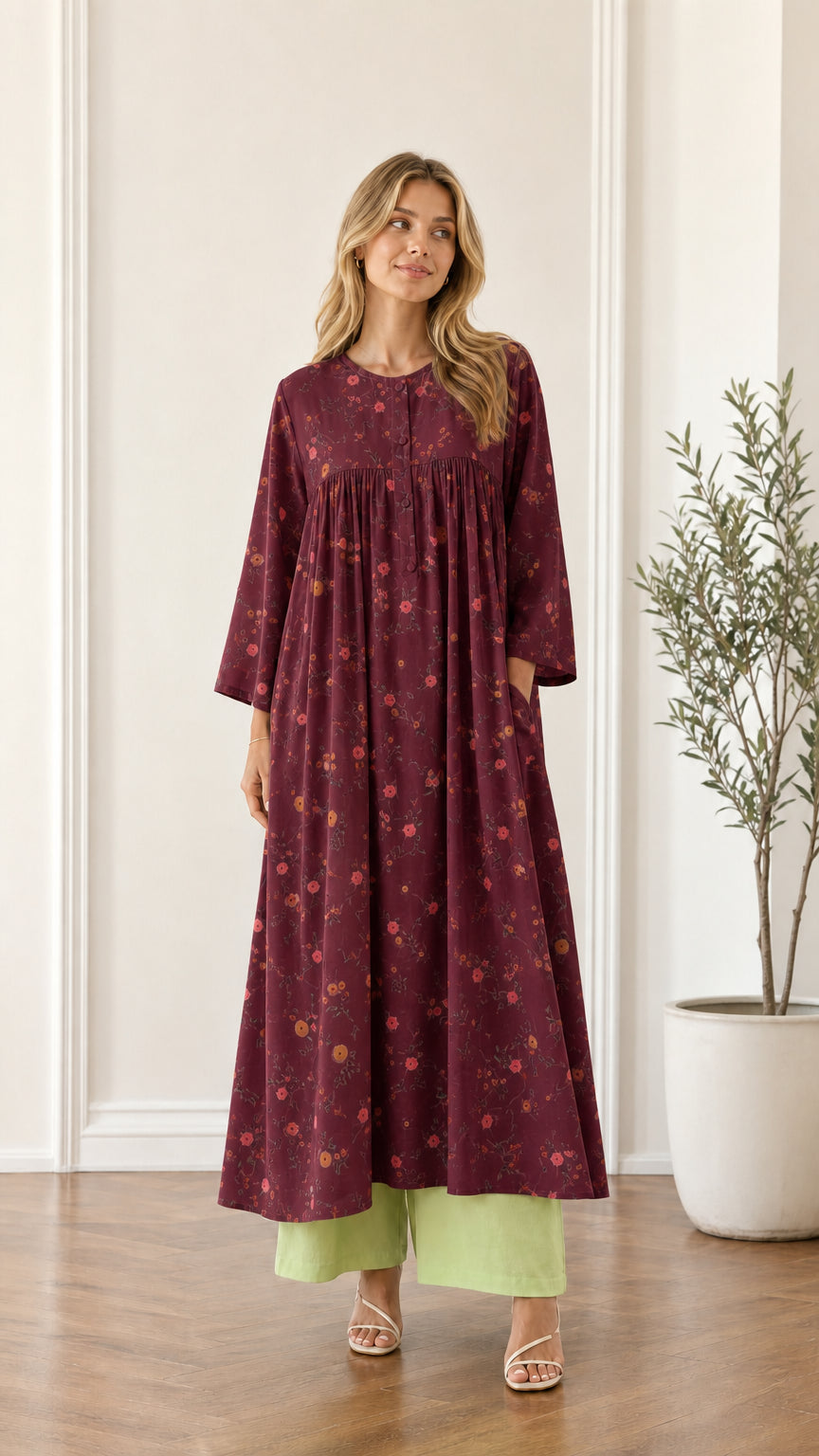 Front view of woman wearing burgundy floral pleated maxi dress