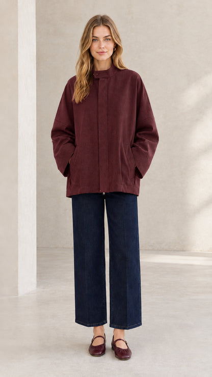 Front view of woman wearing deep burgundy stand collar everyday outerwear jacket