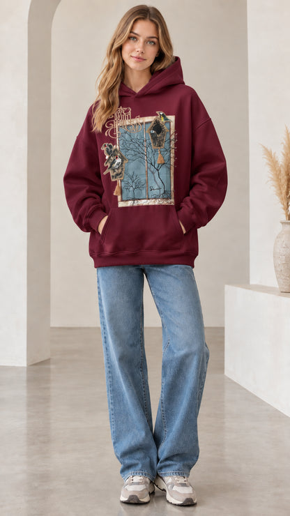 Front view of woman wearing burgundy wine vintage nature bird graphic hoodie