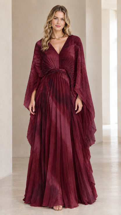 Front view of model wearing rich burgundy wine pleated cape sleeve maxi dress
