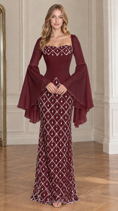 Front view of model wearing Burgundy wine embellished evening gown with dramatic bell sleeves
