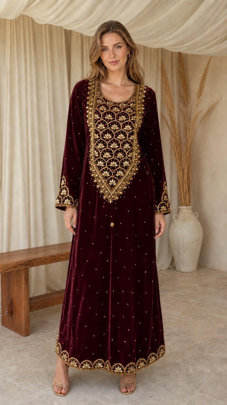 Model posing in burgundy red embroidered velvet maxi kaftan dress