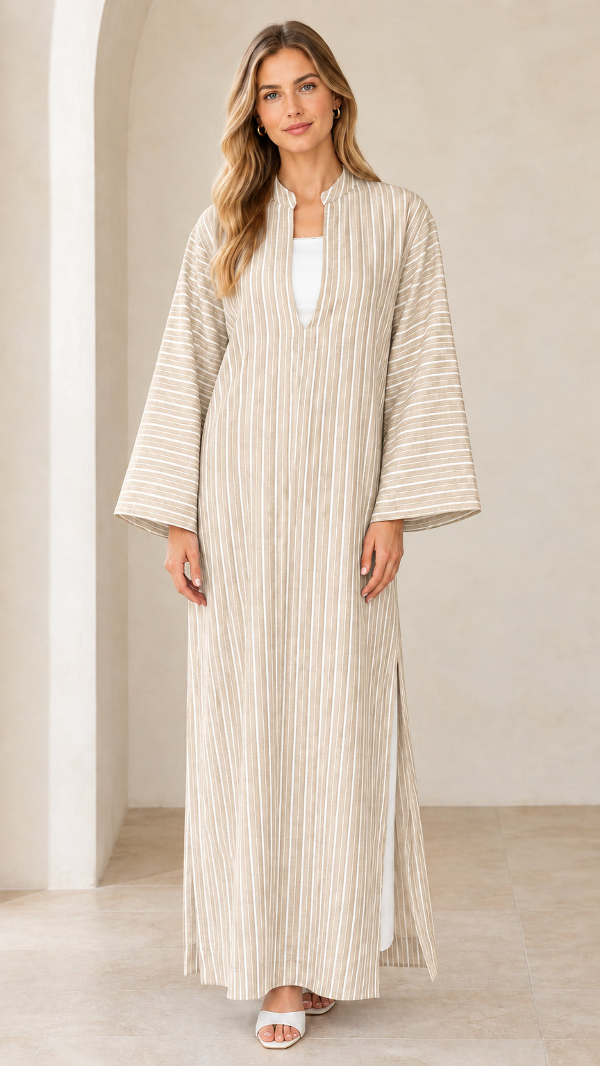 Woman wearing beige neutral vertical striped maxi kaftan dress