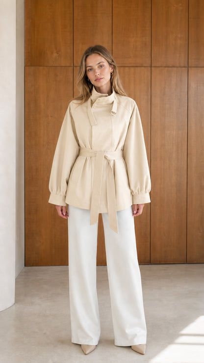 Model wearing beige cream high neck belted short trench jacket