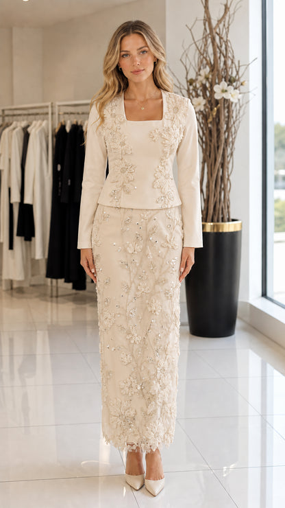 Model wearing champagne cream square neck long-sleeve top and floral embroidered maxi skirt