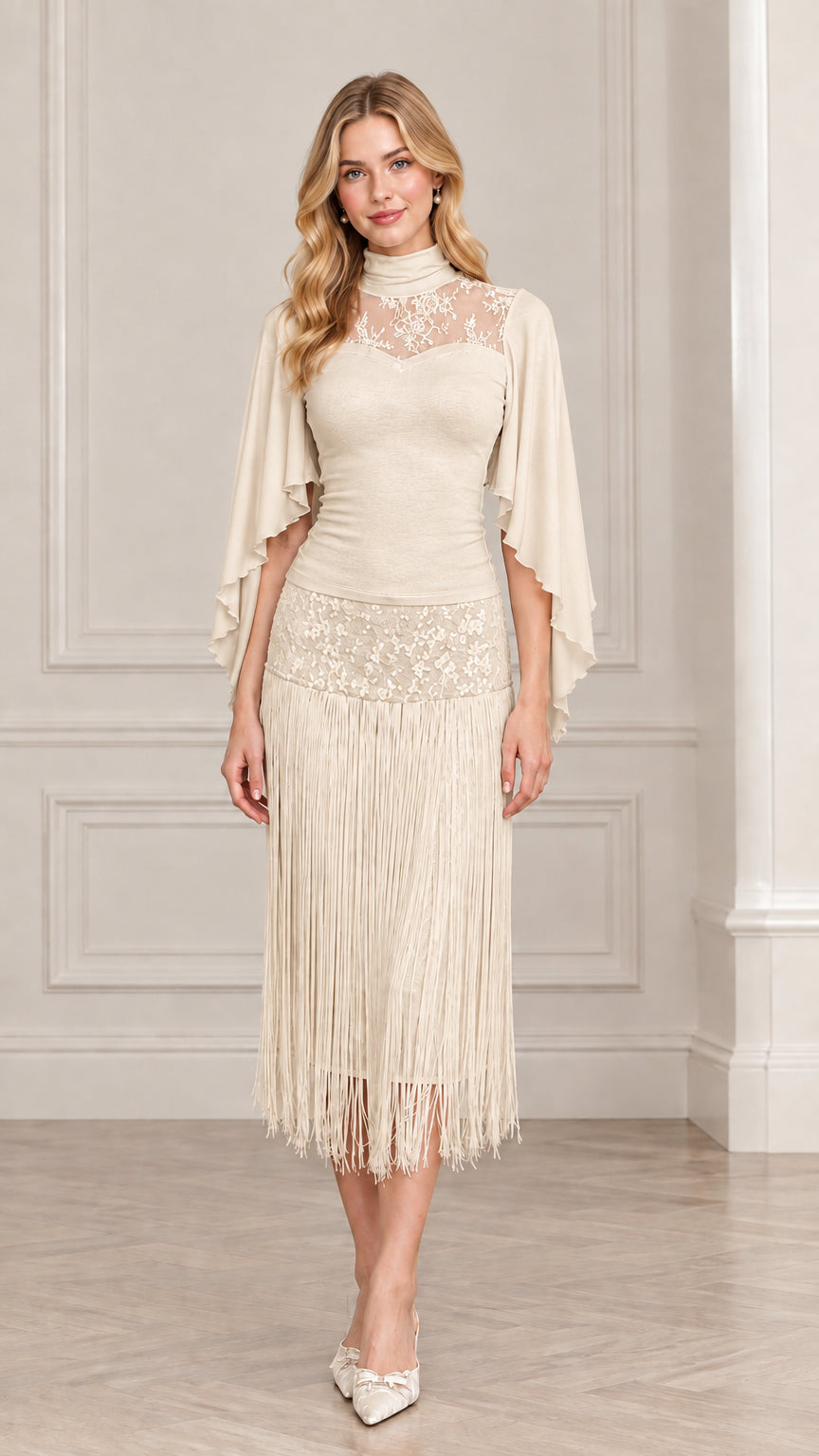 Front view of model wearing champagne cream lace cape sleeve fringe dress