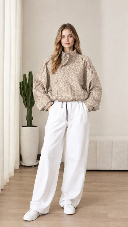 Front view of model wearing beige tan leopard print windbreaker pullover jacket