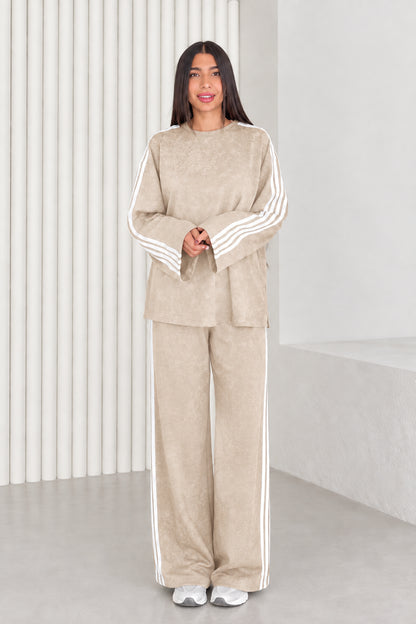 Full length view of model wearing beige two-piece relaxed fit lounge set