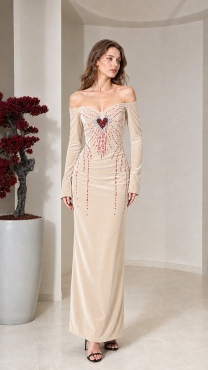 Front view of model wearing champagne velvet off-the-shoulder maxi dress