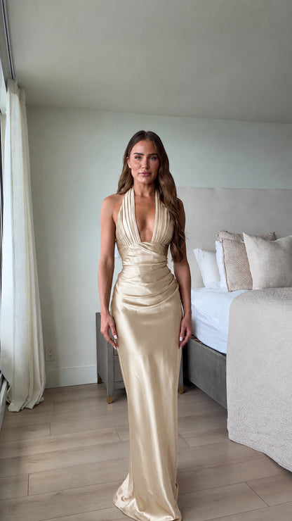 Full-length front view of champagne gold satin halter evening gown