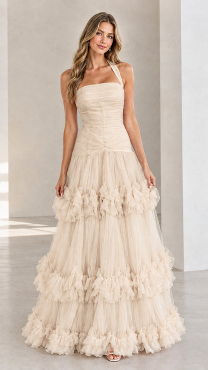 Front view of woman wearing Champagne beige halter neck tiered tulle ball gown