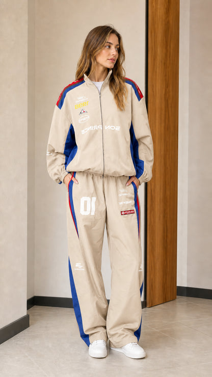 Front view of woman wearing beige colorblock racing two-piece tracksuit set