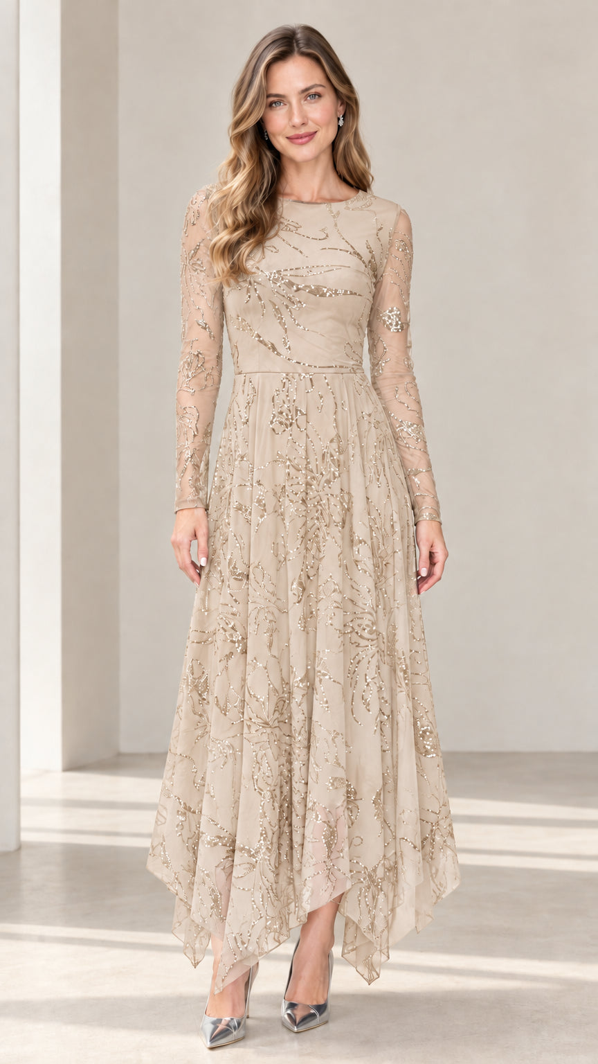 Front view of champagne beige sequin embroidered long sleeve handkerchief hem dress