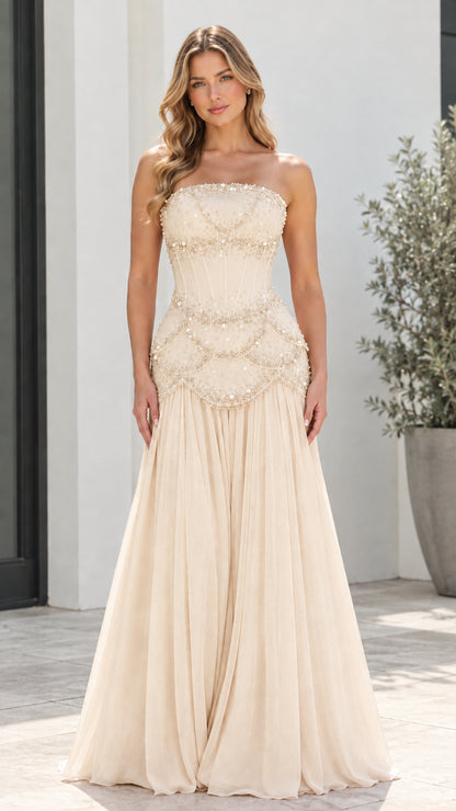 Model wearing Champagne strapless beaded corset pleated evening gown